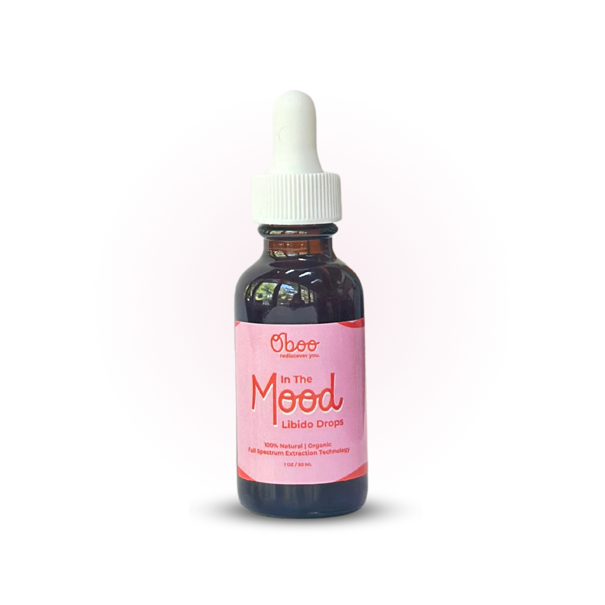 A dark glass dropper bottle labeled "In The Mood Libido Drops" with pink label and white cap, placed on white background.