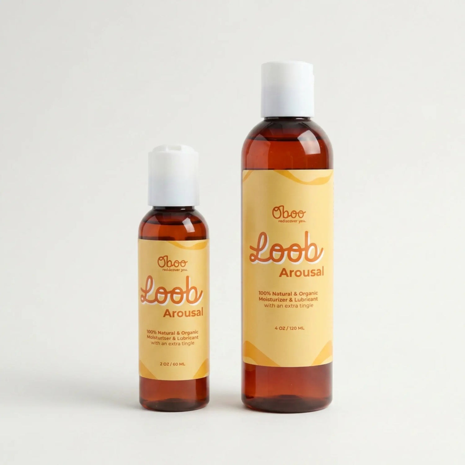 Two sizes of Oboo Loob Arousal Moisturizer — a 2oz travel bottle and a 4oz everyday bottle, side by side on a soft white background