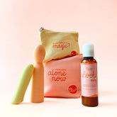 Two colorful massagers, a bottle of Oboo Loob Daily lubricant, and two pouches with playful quotes are displayed on a peach background.