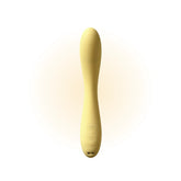 Yellow wand massager standing upright against a clean white background, showcasing its smooth texture and rounded design details.