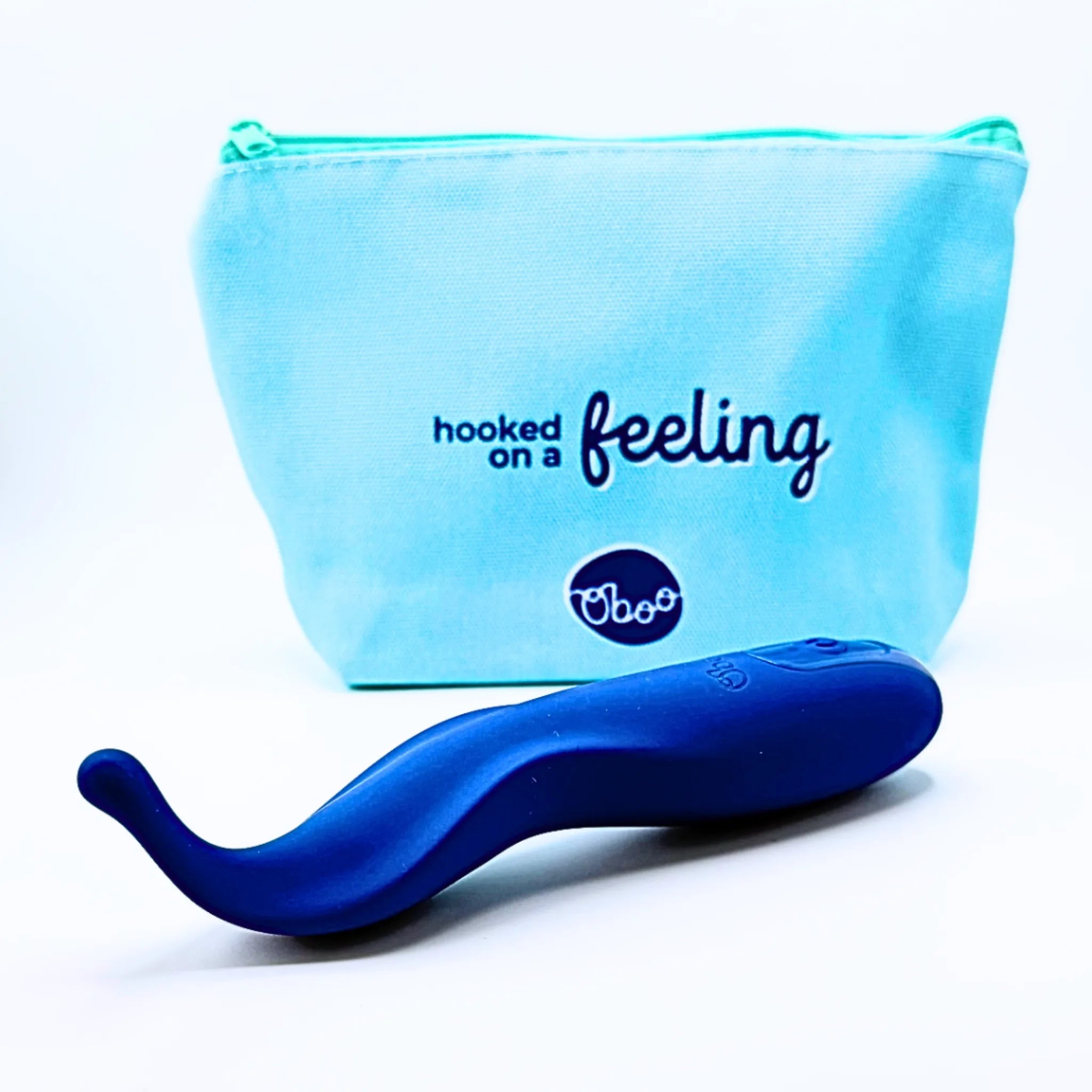 Blue Nook Clitoral Massager beside its teal hooked-on-a-feeling Oboo pouch — discreet storage for partnered pleasure