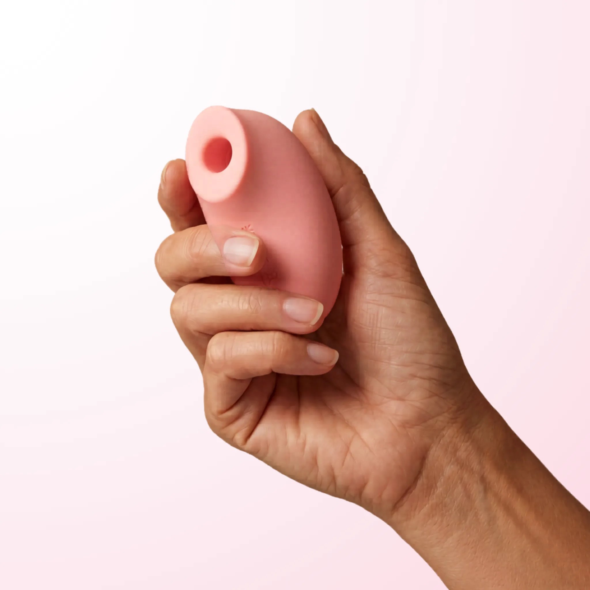 Pink Smooch Sonic Stimulator angled side view showing curved silicone head
